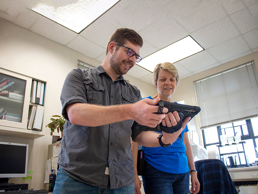 Man and woman looking at a tablet together in an office setting