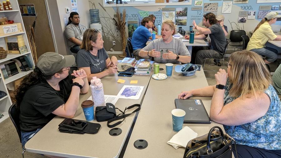 Adults having a discussion around a table